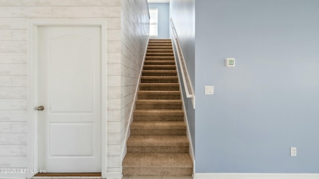 stairway featuring baseboards