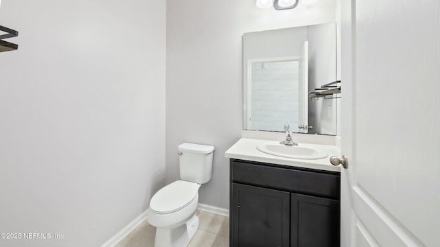 bathroom featuring baseboards, vanity, and toilet