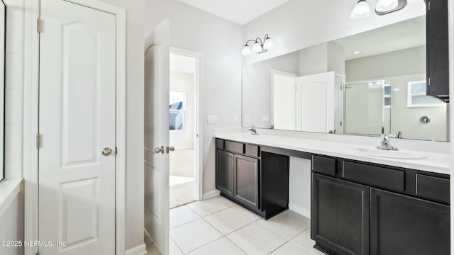 bathroom featuring double vanity, a sink, and tile patterned floors