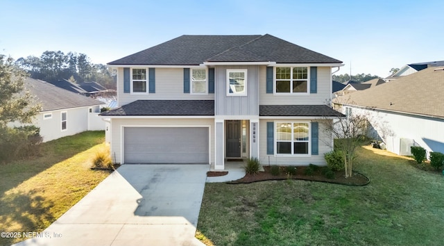 traditional home featuring a front yard, roof with shingles, driveway, and an attached garage