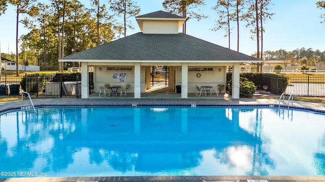 community pool featuring fence and a patio