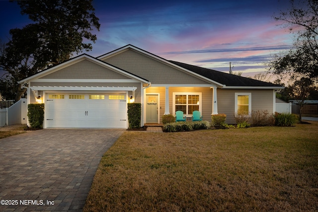 view of front facade featuring a garage and a yard