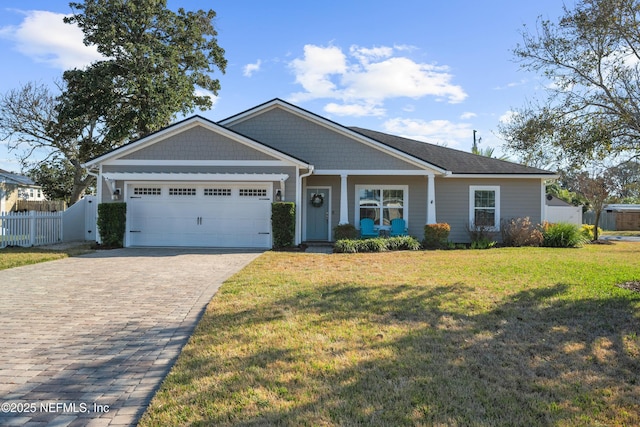 view of front of home with a garage and a front lawn