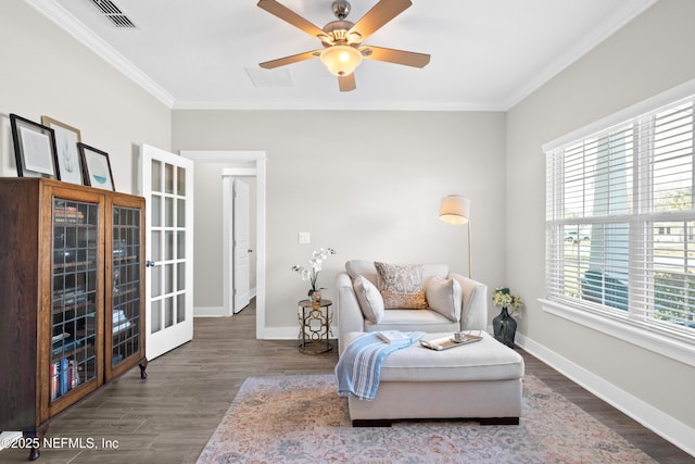 living area with crown molding, ceiling fan, and dark wood-type flooring