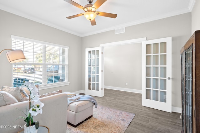 living room with dark hardwood / wood-style floors, ornamental molding, french doors, and ceiling fan