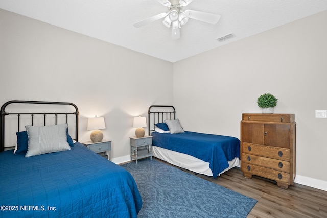 bedroom with ceiling fan and dark hardwood / wood-style flooring