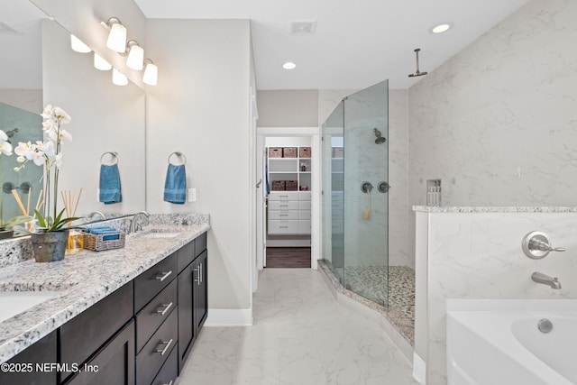 bathroom featuring independent shower and bath and vanity