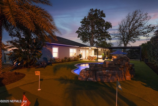 view of pool at dusk