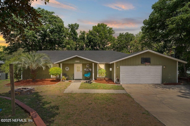 ranch-style house with central AC, a garage, and a lawn