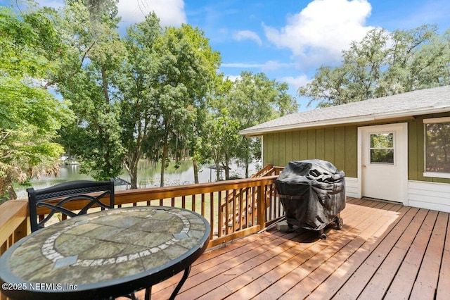 wooden deck featuring a grill and a water view