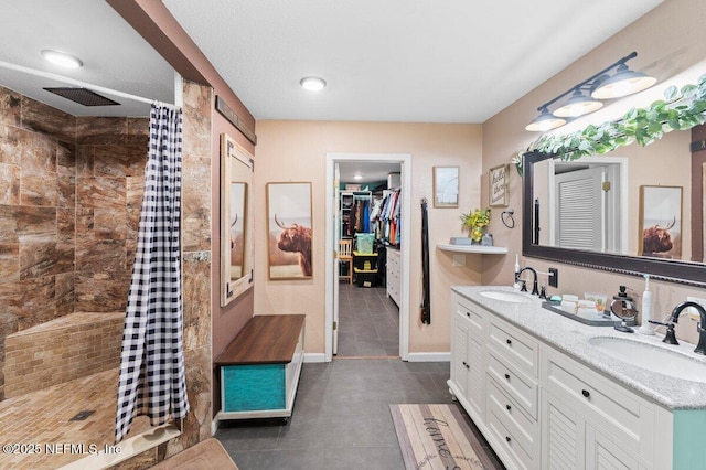 bathroom featuring vanity and curtained shower