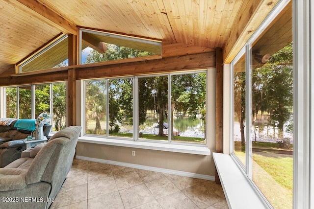 unfurnished sunroom featuring a water view, plenty of natural light, and vaulted ceiling with beams