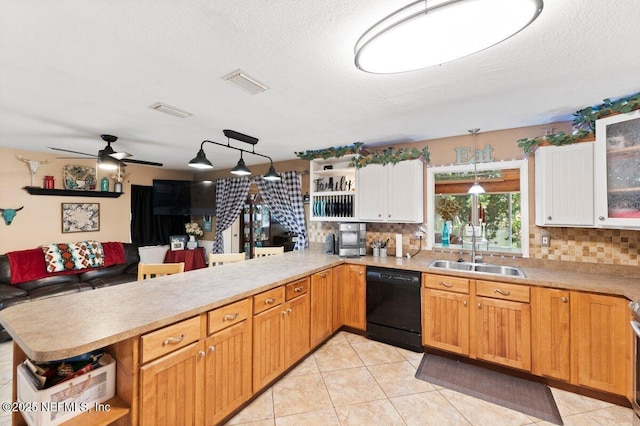 kitchen with white cabinetry, black dishwasher, sink, and kitchen peninsula