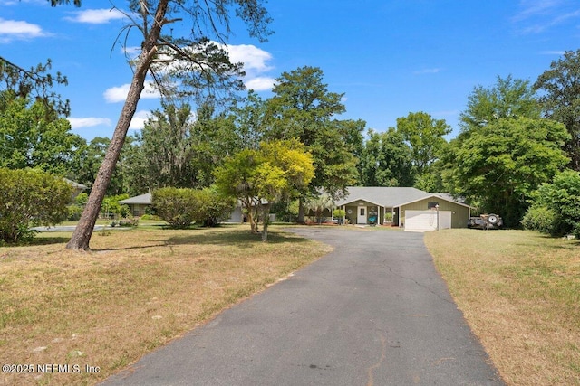 single story home featuring a garage and a front yard