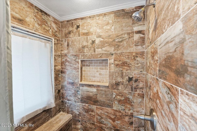 bathroom with ornamental molding, tiled shower, and a textured ceiling