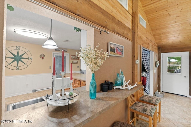 foyer featuring light tile patterned flooring, vaulted ceiling, and wood ceiling