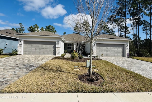 ranch-style home with a garage and a front lawn