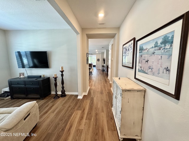 hall with hardwood / wood-style flooring