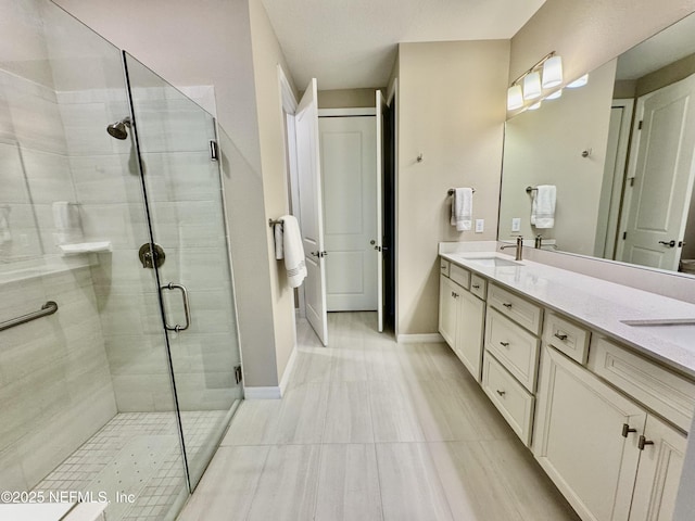 bathroom with vanity and a shower with door