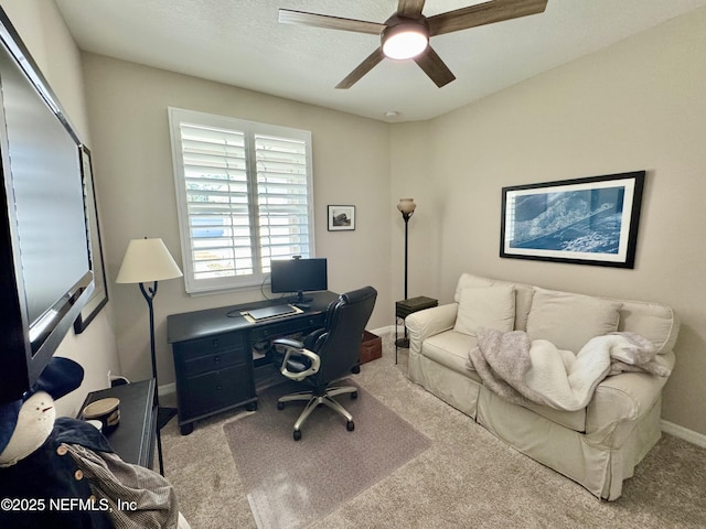 office space featuring light carpet and ceiling fan