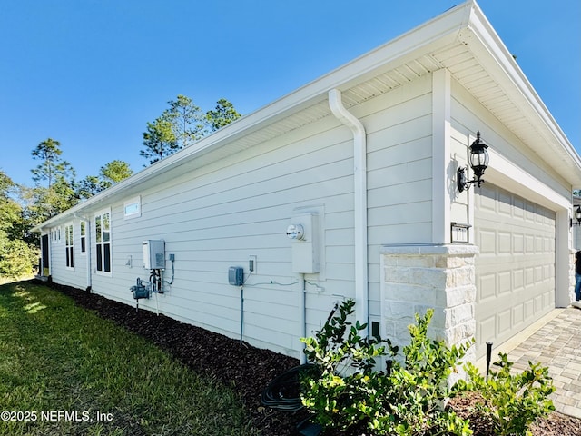 view of side of property with a garage