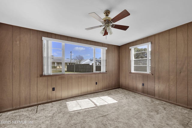 unfurnished room featuring light carpet and ceiling fan