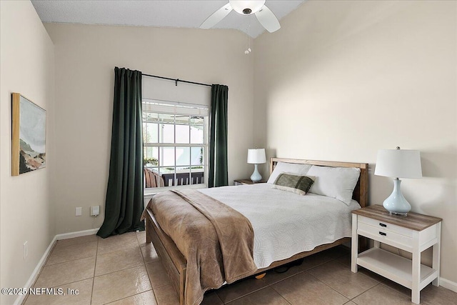 tiled bedroom with vaulted ceiling and ceiling fan