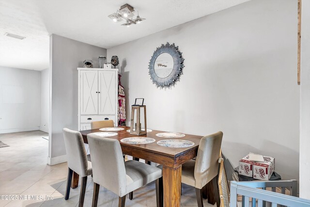 dining area with visible vents, baseboards, and light tile patterned flooring