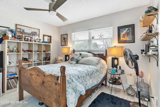 bedroom with light wood-type flooring and ceiling fan