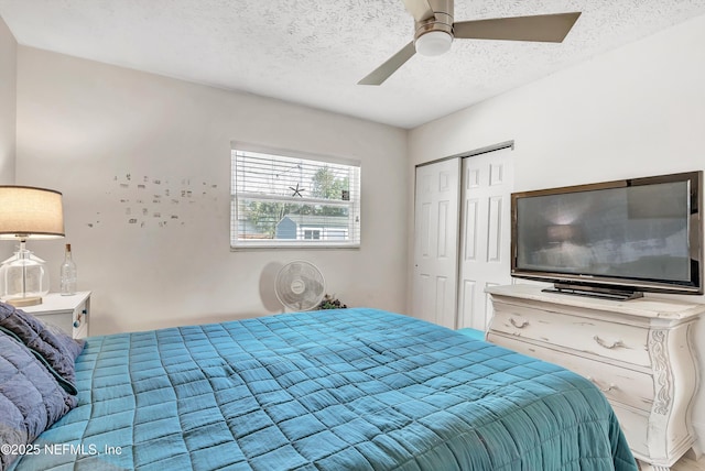 bedroom with a closet, ceiling fan, and a textured ceiling