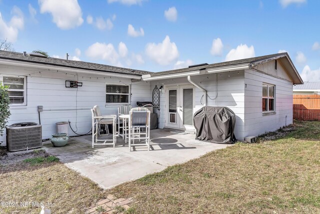 rear view of property with central AC, a lawn, a patio, and fence