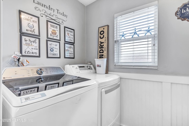 laundry room with laundry area, separate washer and dryer, and wainscoting