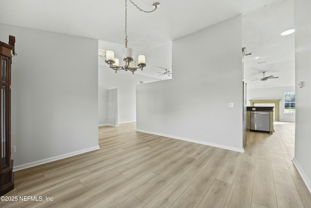 interior space featuring light wood-type flooring and ceiling fan with notable chandelier