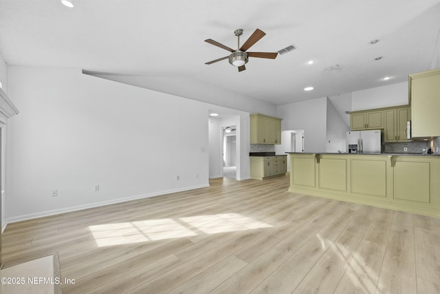 unfurnished living room with light wood-type flooring, lofted ceiling, and ceiling fan