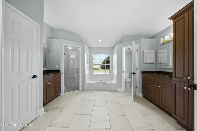 full bathroom featuring vanity, independent shower and bath, toilet, and a textured ceiling