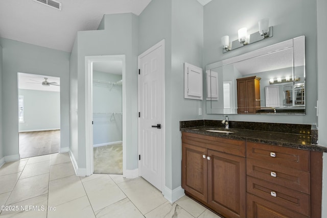 bathroom with ceiling fan and vanity