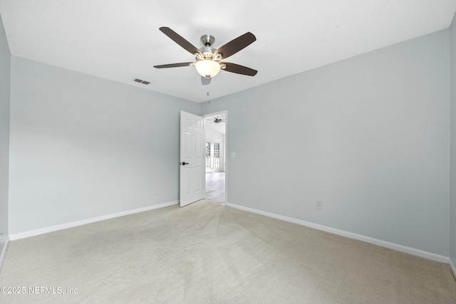 unfurnished room with ceiling fan and light colored carpet