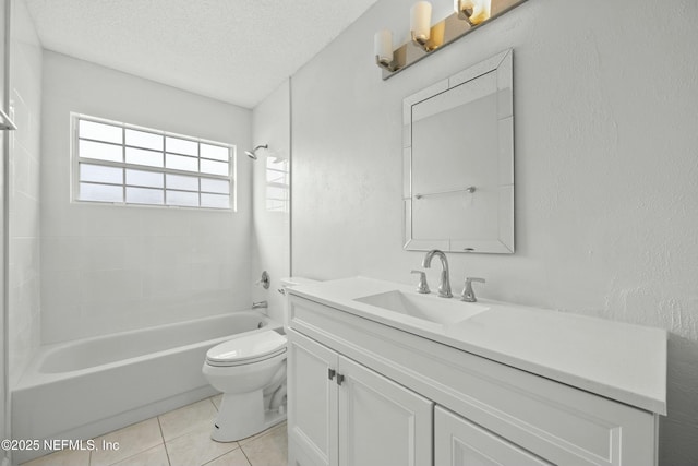 full bathroom featuring vanity, a textured ceiling, tiled shower / bath, tile patterned flooring, and toilet