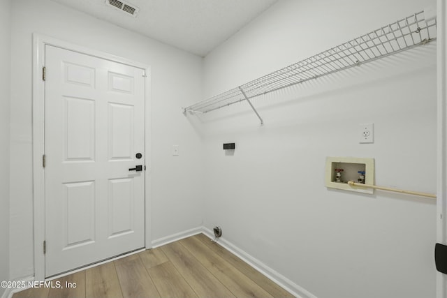 laundry room featuring light wood-type flooring and washer hookup