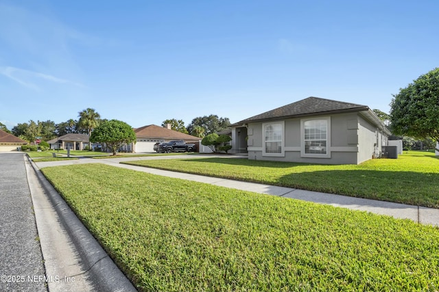 view of front of house featuring central AC unit and a front yard