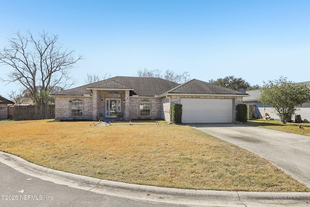 view of front of property featuring a garage and a front lawn