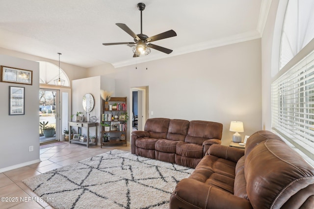 tiled living room with crown molding and ceiling fan