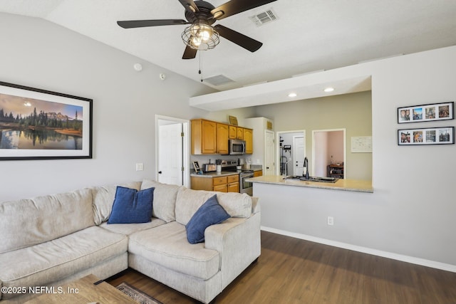 living room featuring lofted ceiling, sink, dark hardwood / wood-style floors, and ceiling fan