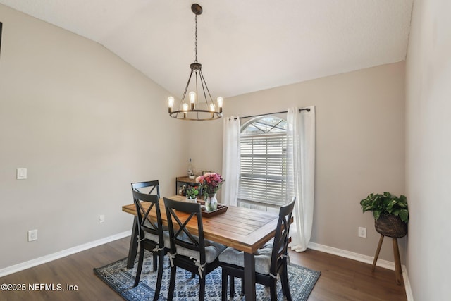 dining space featuring vaulted ceiling, dark wood-type flooring, and a notable chandelier