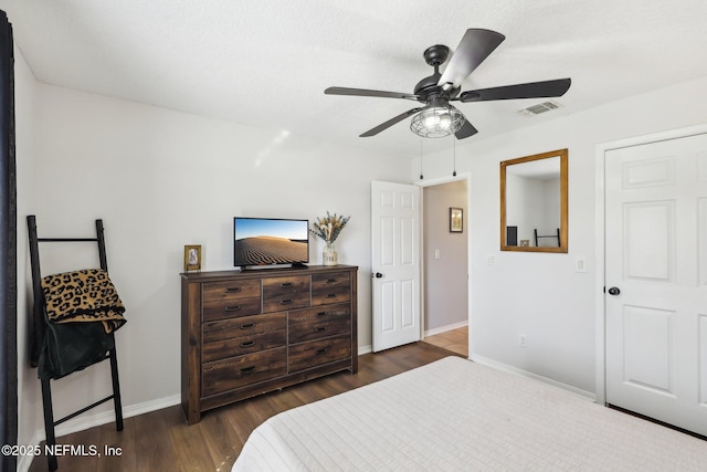 bedroom with dark wood-type flooring and ceiling fan