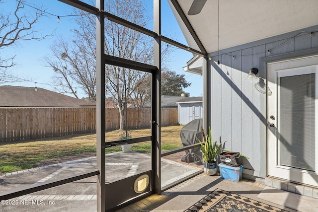 unfurnished sunroom featuring a healthy amount of sunlight and vaulted ceiling