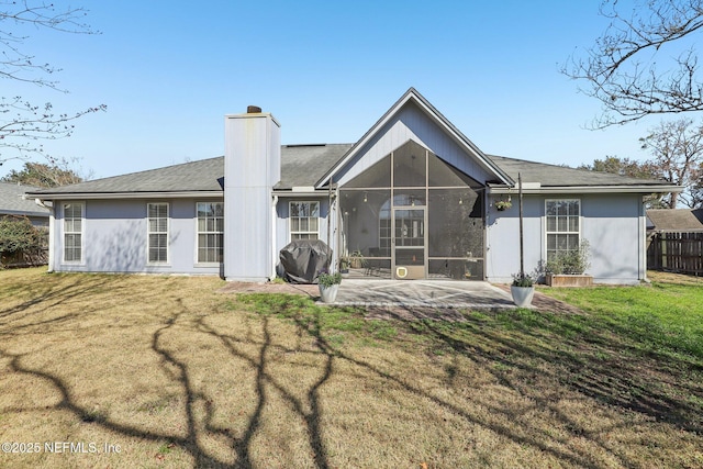 rear view of property with a lawn and a patio area