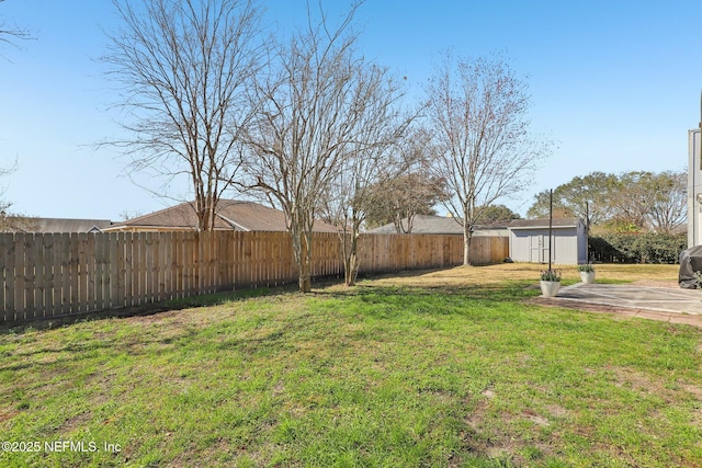 view of yard featuring a storage shed and a patio