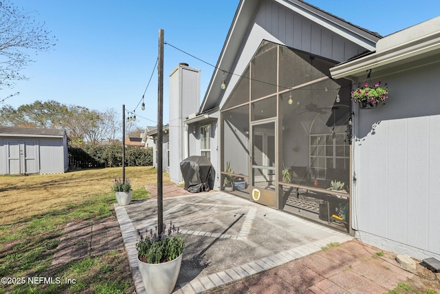 view of patio / terrace featuring grilling area and a storage unit