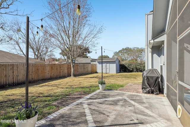 view of yard featuring a storage shed and a patio area